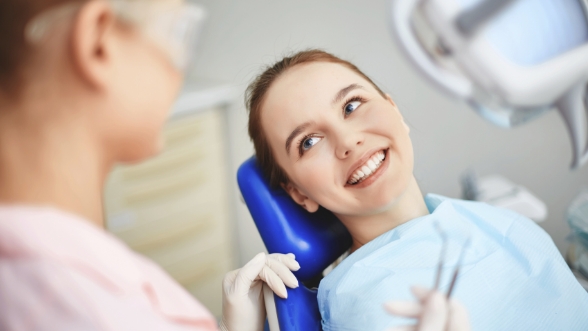 Young woman smiling while sitting in dental chair