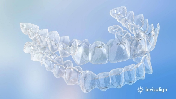 Two Invisalign clear aligners on light blue background